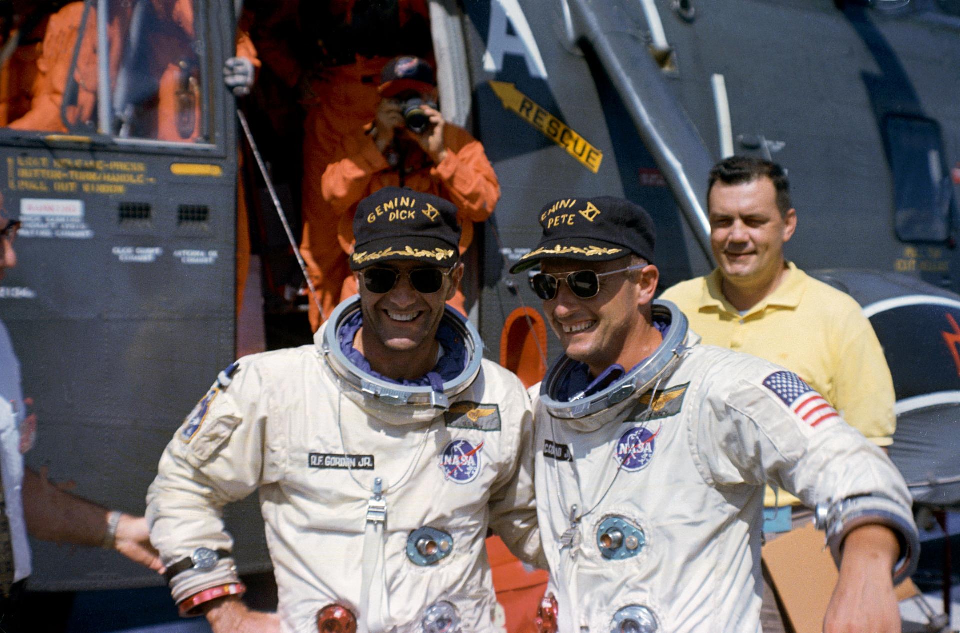 The Gemini XI prime crew, astronauts Charles Conrad Jr. and Richard F. Gordon Jr. pose in front of the recovery helicopter on the USS Guam.