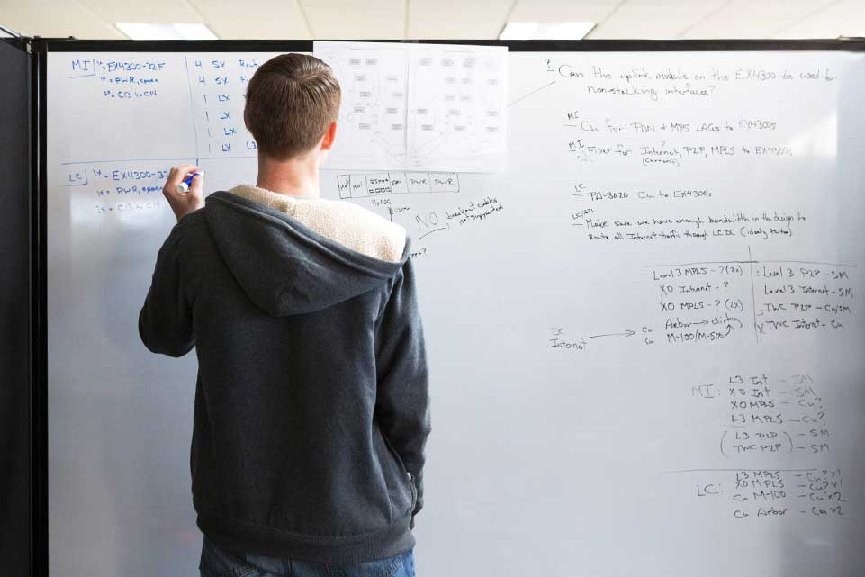 A CoverMyMeds employee writing on a whiteboard