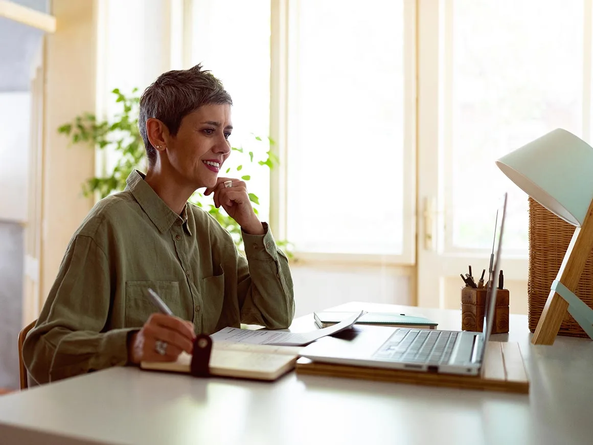 Woman following online course on laptop