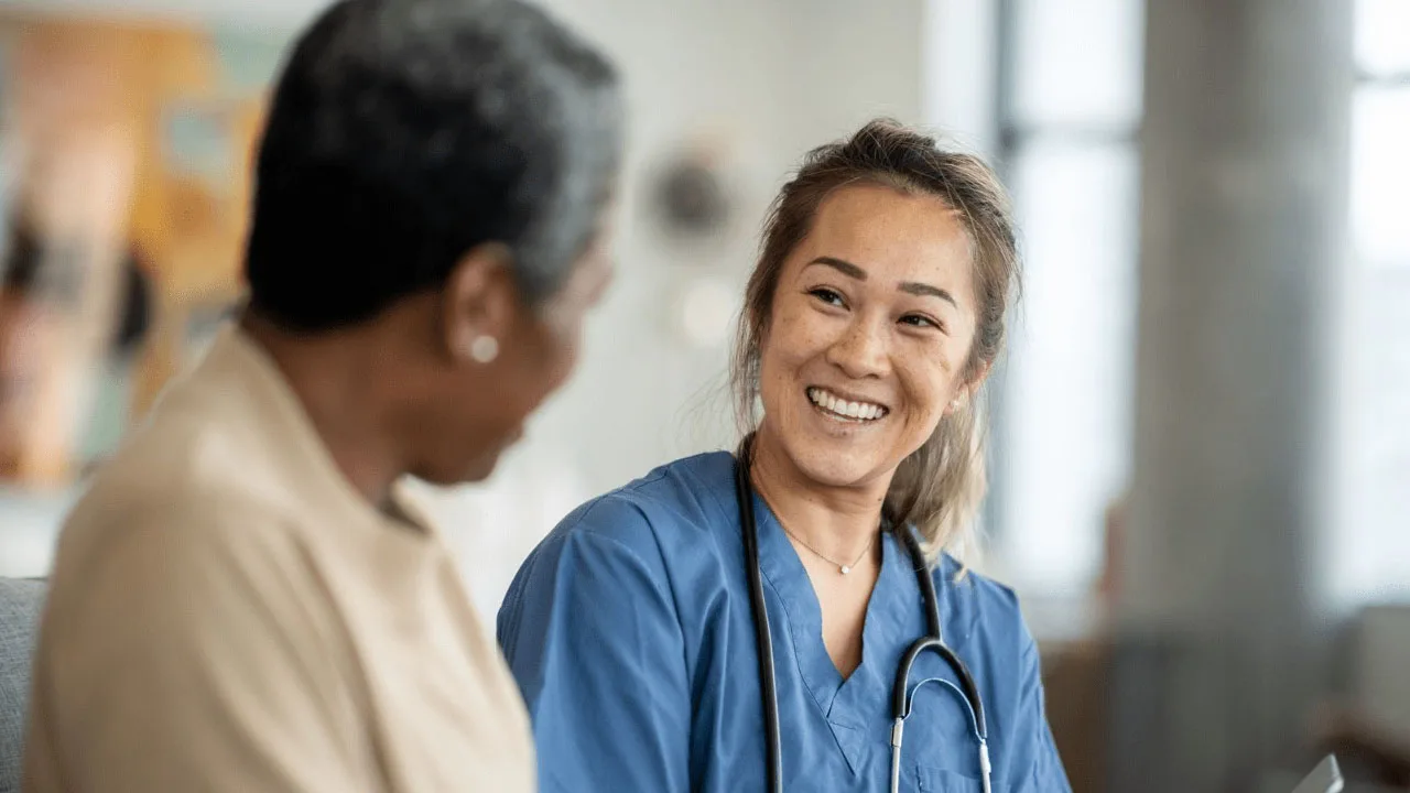 A doctor and patient chatting in a medical setting