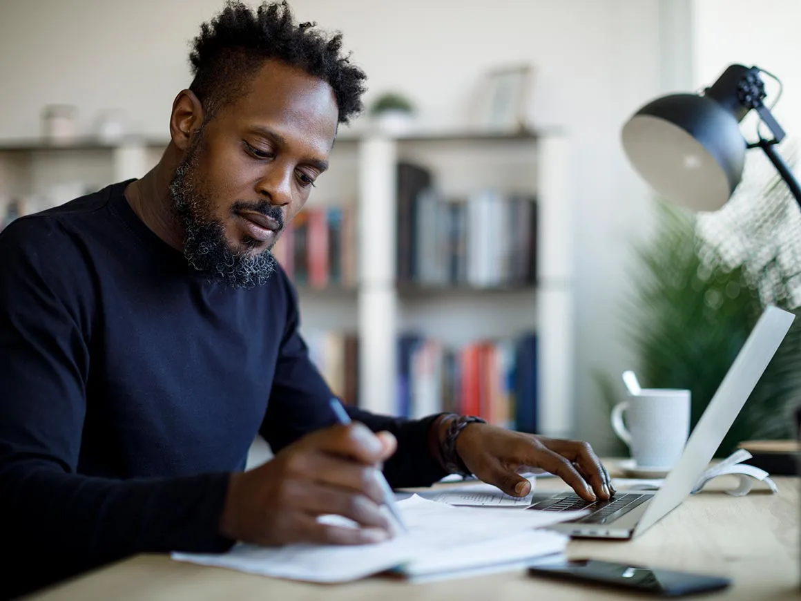 Man working at home writing