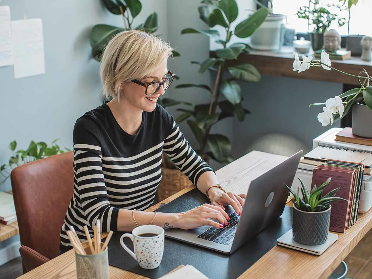 Female author working on laptop in office