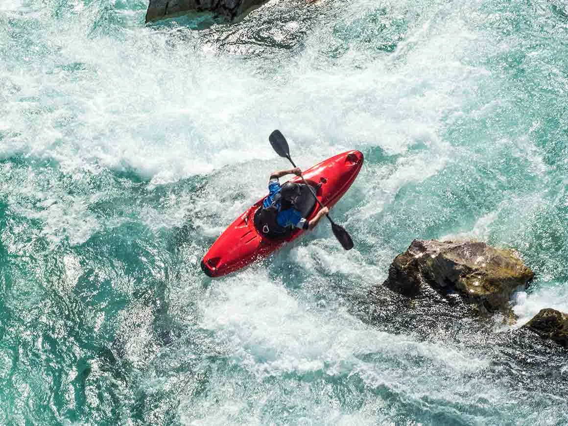 Person kayaking on white water