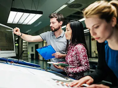 Photo depicting an engineering team collaborating (Source: TommL/E+ via Getty Images)