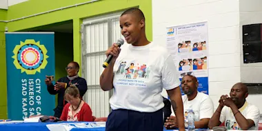 Dr Zolelwa Sifumba addresses community members, NGOs and other stakeholders as emcee of TB Proof’s World Aids Day 2022 event in Khayelitsha, Cape Town.