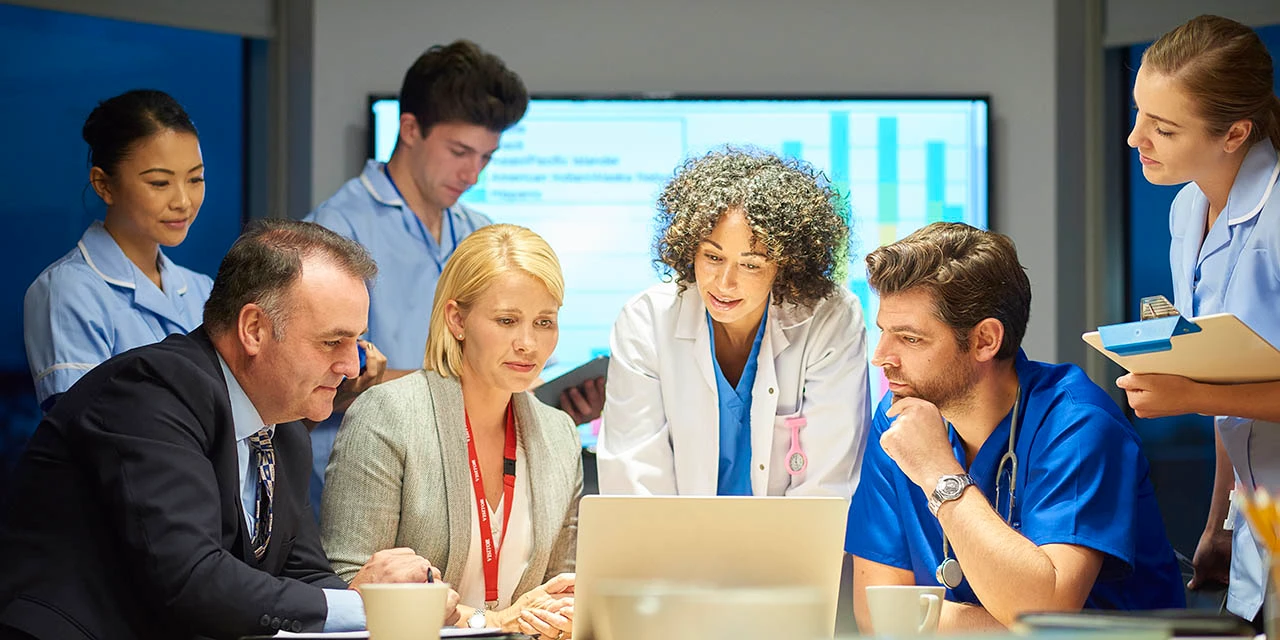 Photo depicts a meeting of business leaders and medical professionals (Source: Sturti/E+ via Getty Images)