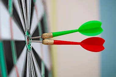 2 dart arrows in bulls eye on dart board