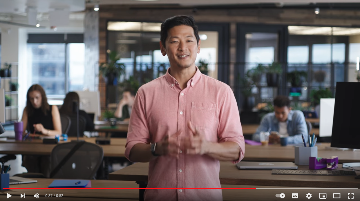 Video screenshot of a man standing in an office