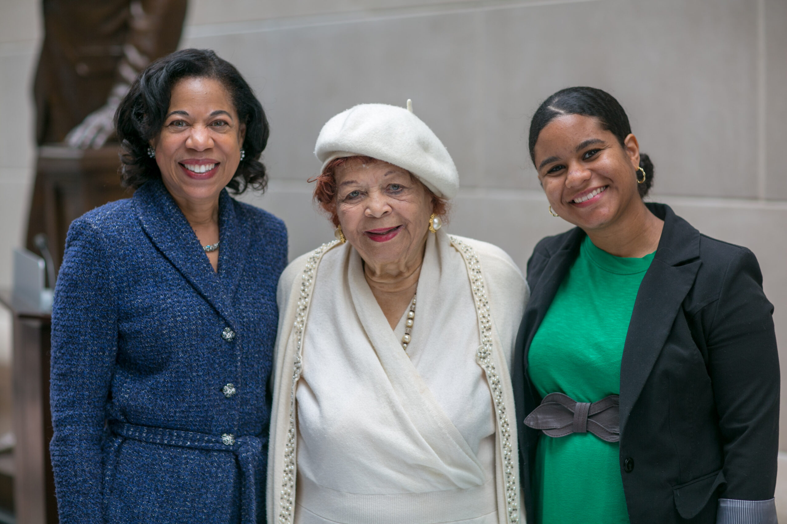 Three women dressed in formal business suits