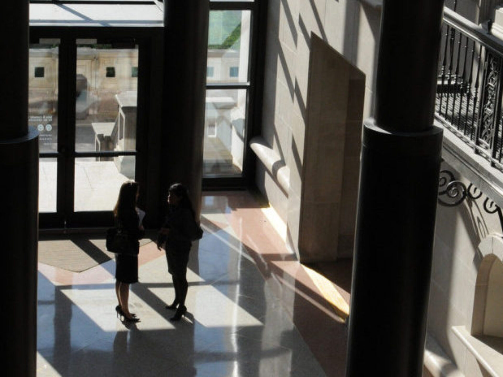 students in silhouette, standing in pavilion