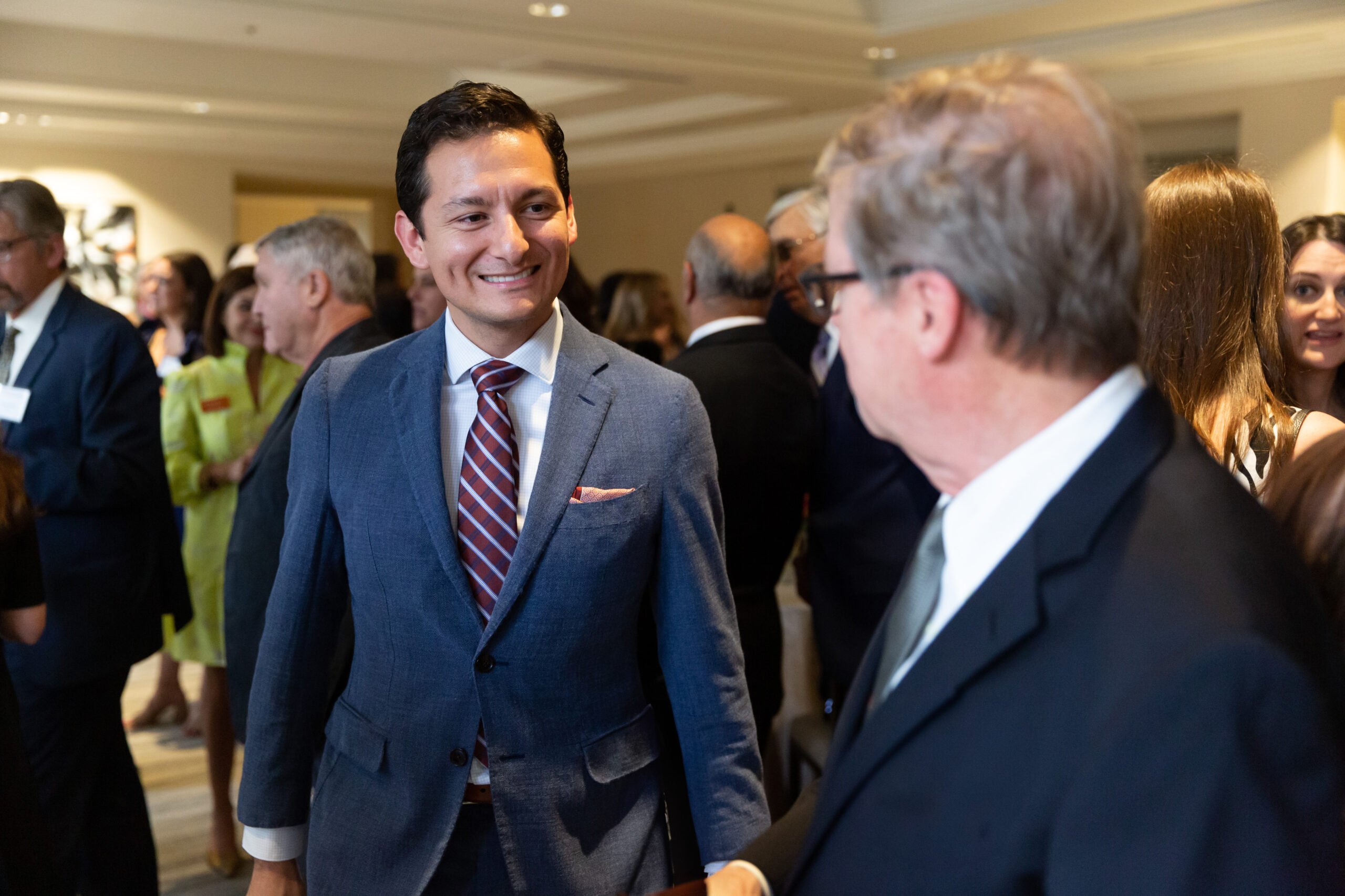 men wearing suits talking to each other