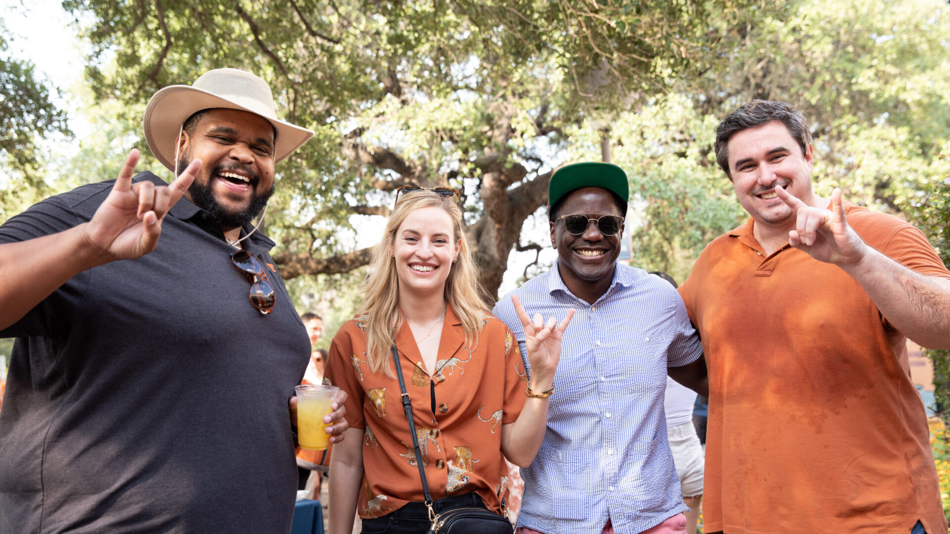 A photo of 4 alumni at the 2022 Tailgate Extravaganza