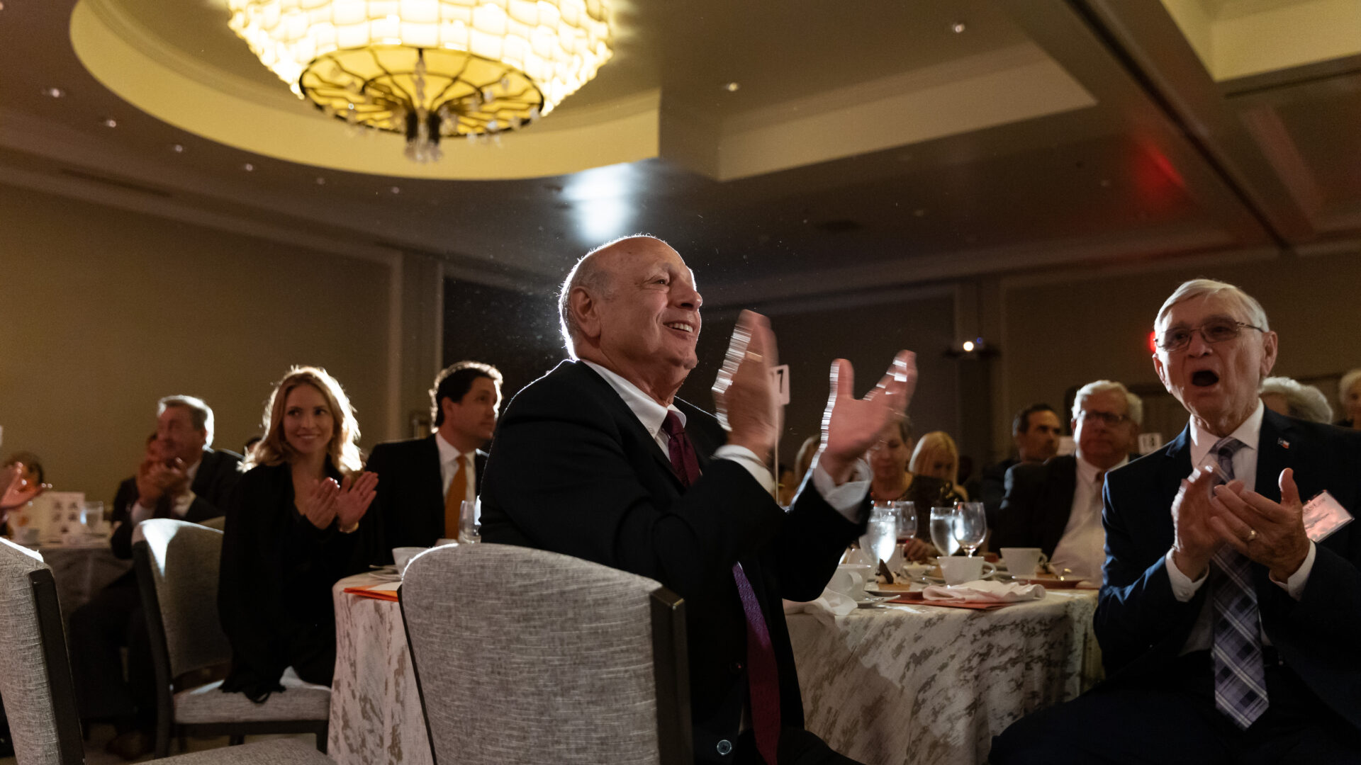 A group of alumni at the 2023 Alumni Awards applauding for an award recipient.