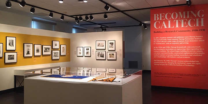 The main room of the exhibit: images on the walls and artifacts at the center