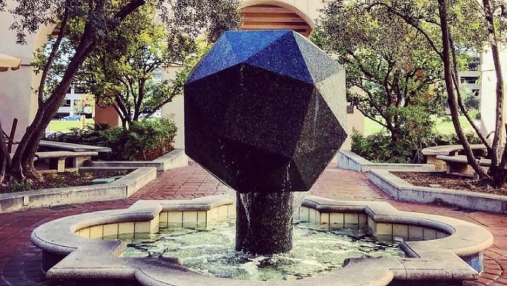 Polygonal sculpture in building courtyard