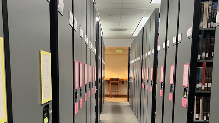 library shelves on either side of aisle