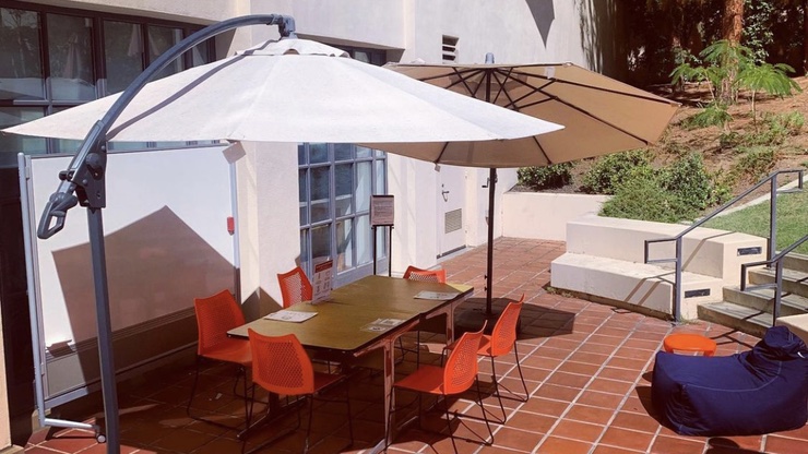 outdoor table and chairs and red umbrellas