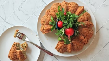 A savory bundt cake with herbs and radishes in the center.