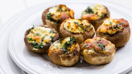 Stuffed mushrooms on a white plate.