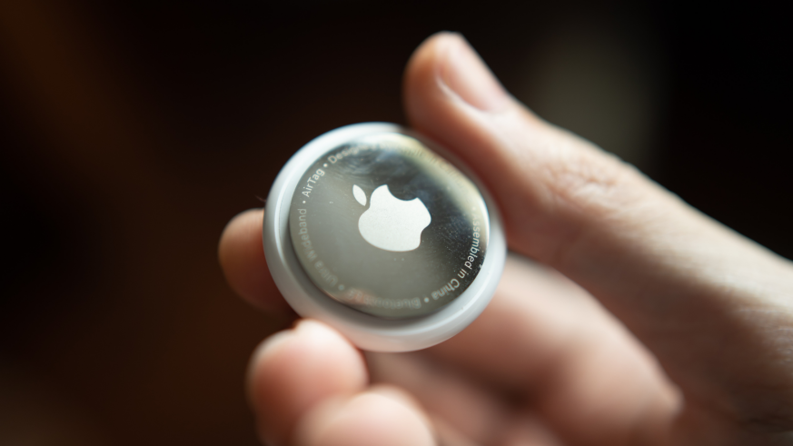 Close-up image of a hand holding an airtag