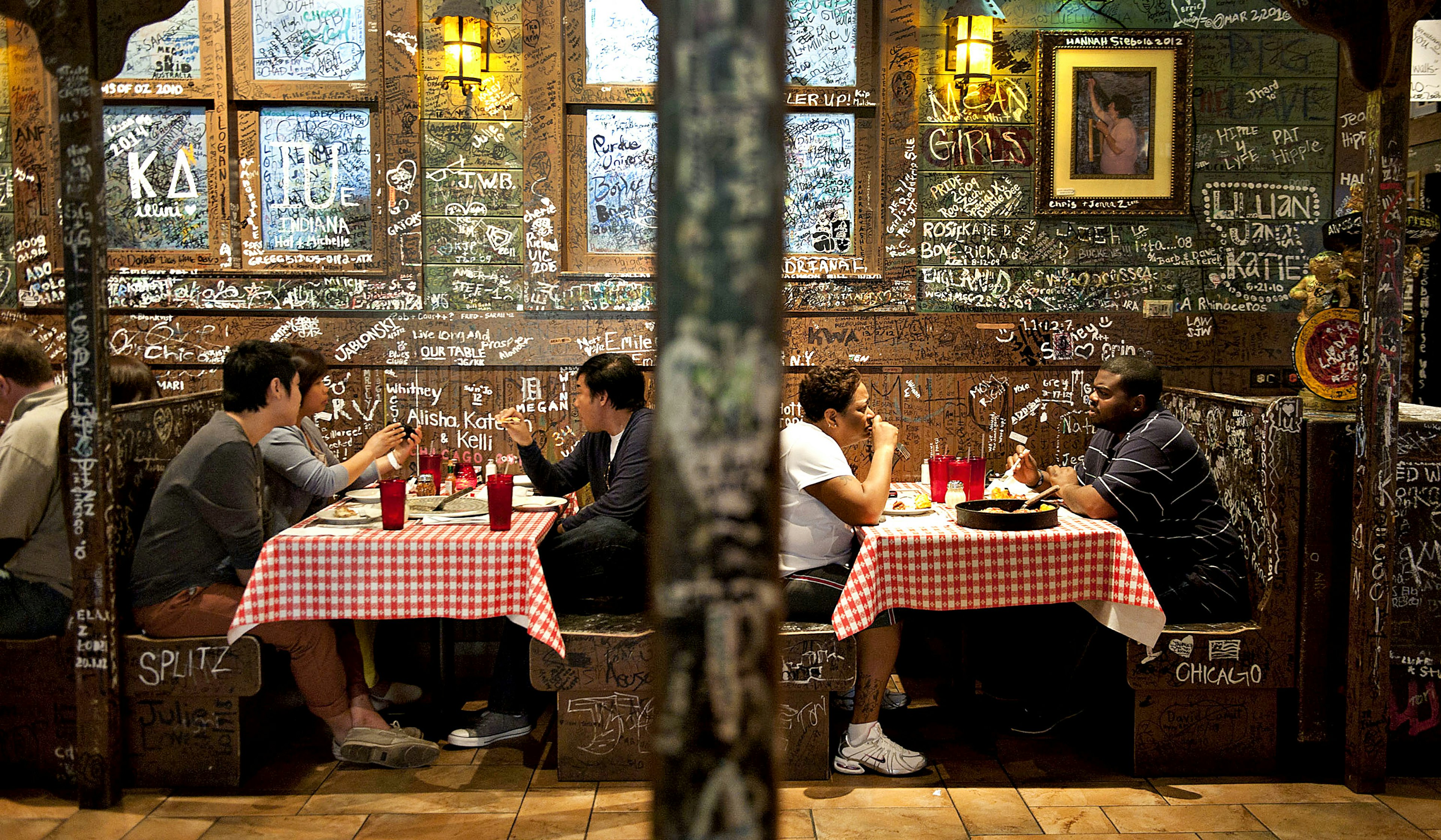 Customers sit in the dining room at Gino's East restaurant in Chicago, Illinois.