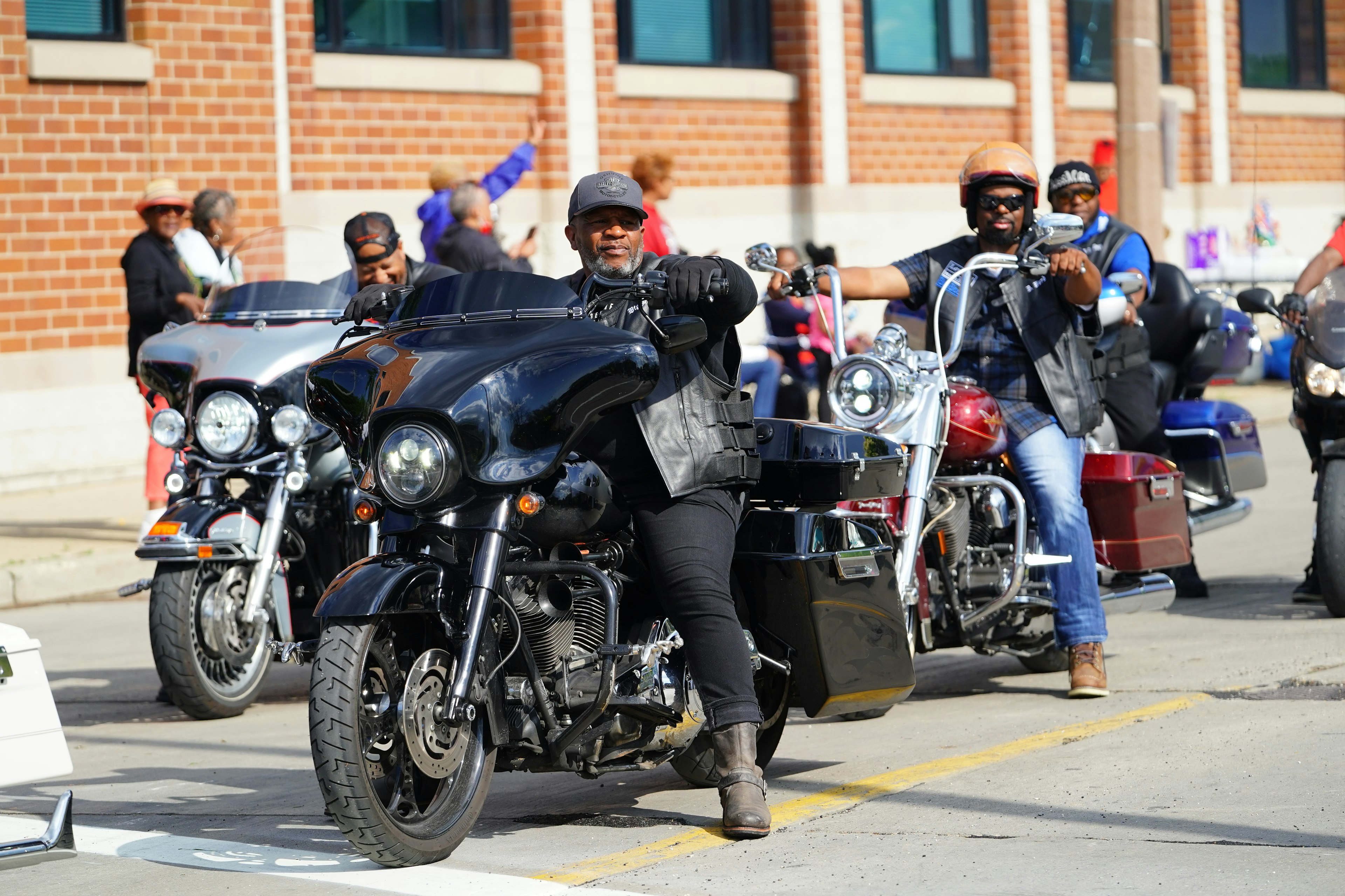 A group of Harley-Davison motorcycle riders in Milwaukee, Wisconsin, on a sunny day