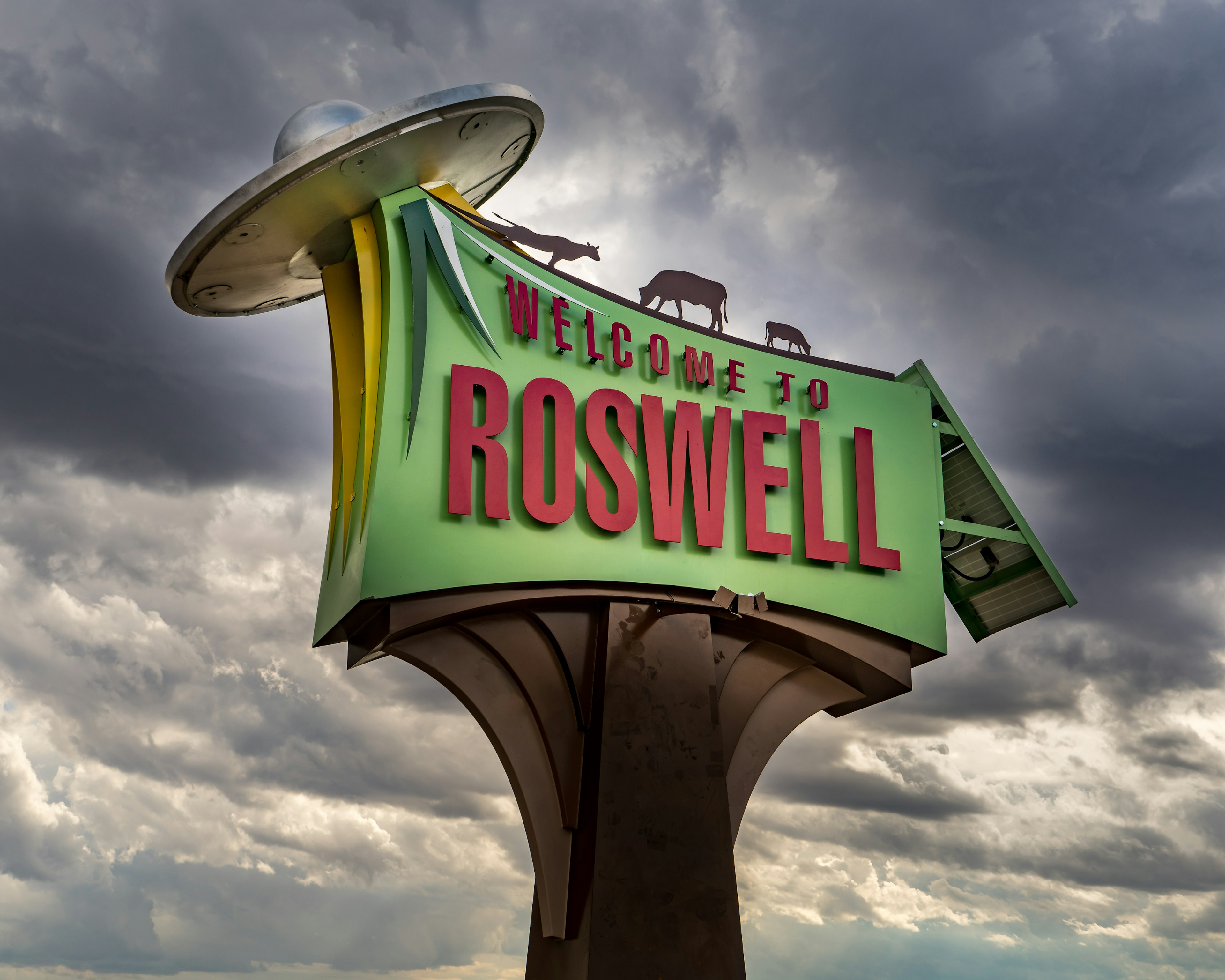 Welcome to Roswell sign with animals beaming into a flying saucer, in New Mexico.