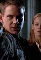 Scott Bairstow and Samantha Mathis in Harsh Realm (1999)