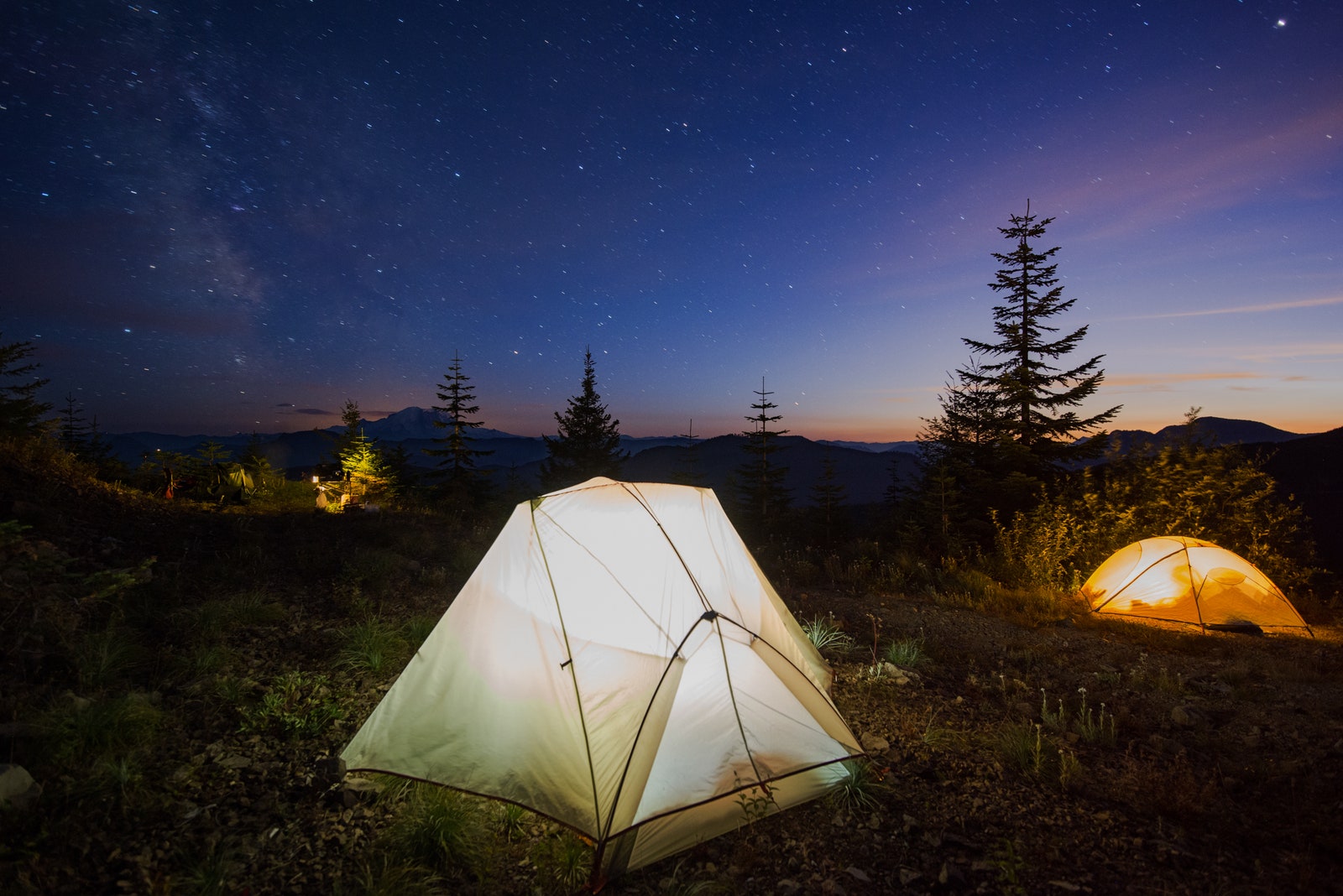 Illuminated tents against on field star field