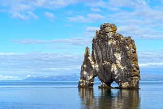 Image may contain Shoreline Water Outdoors Nature Ocean Sea Land Cliff Coast Rock Promontory Cove and Cave