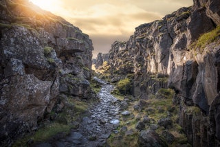 Image may contain Nature Outdoors Cliff Water Mountain Stream and Creek