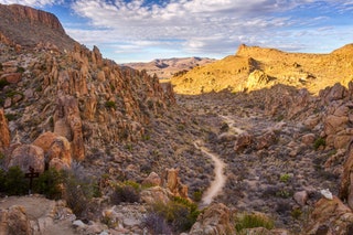 Image may contain Nature Outdoors Wilderness Rock Landscape Scenery Mountain Valley Canyon Road Path and Trail