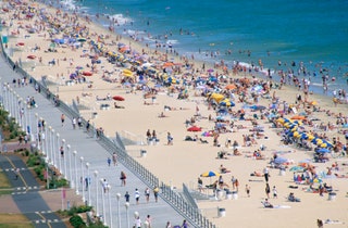 Image may contain Person Crowd Outdoors Nature Sea Water People Waterfront Beach Coast Shoreline and Boardwalk