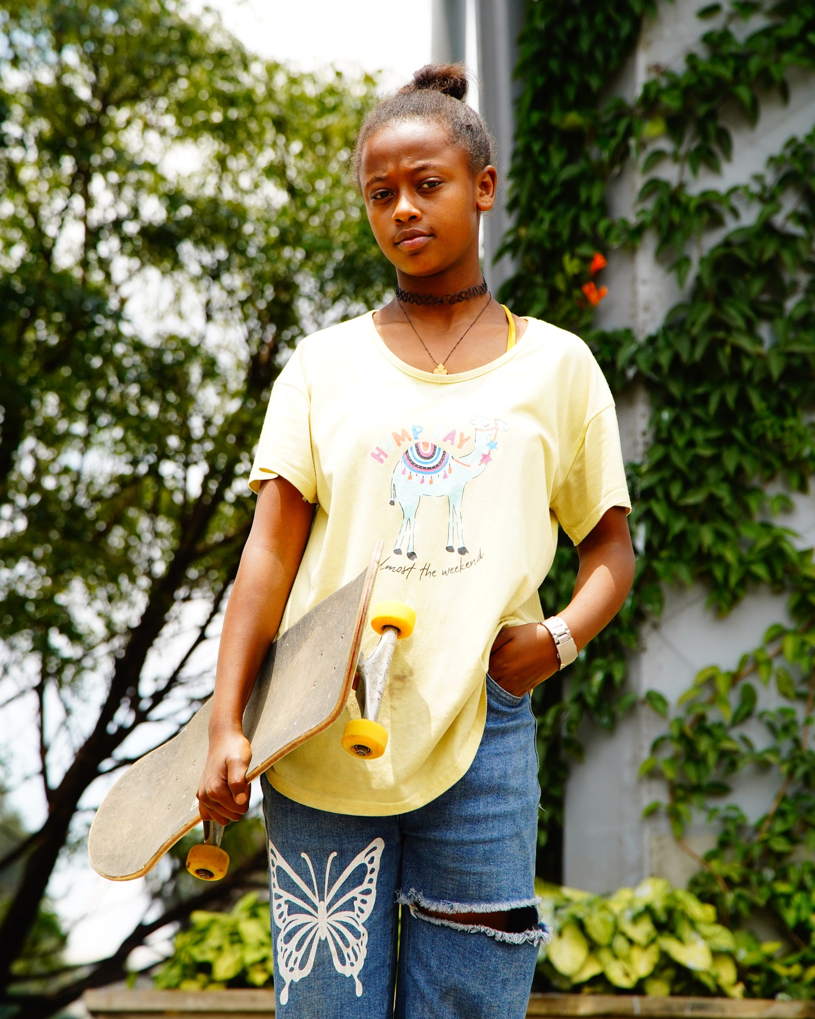 Image may contain Clothing Sleeve Child Person Accessories Jewelry Necklace Pants Skateboard TShirt and Bracelet