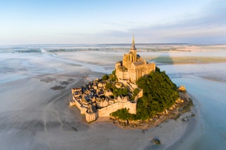 Image may contain Architecture Building Castle Fortress Nature Outdoors Sea Water Land Scenery Beach and Coast