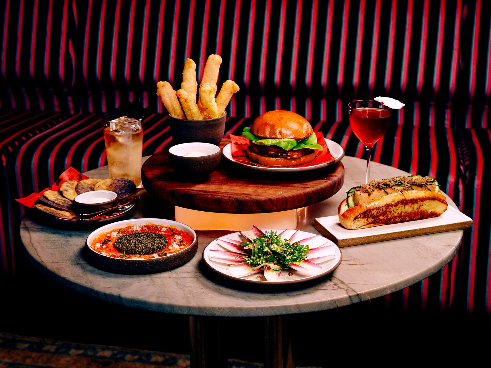 A photo of a table at Clemente Bar set with plates of food and beverages.