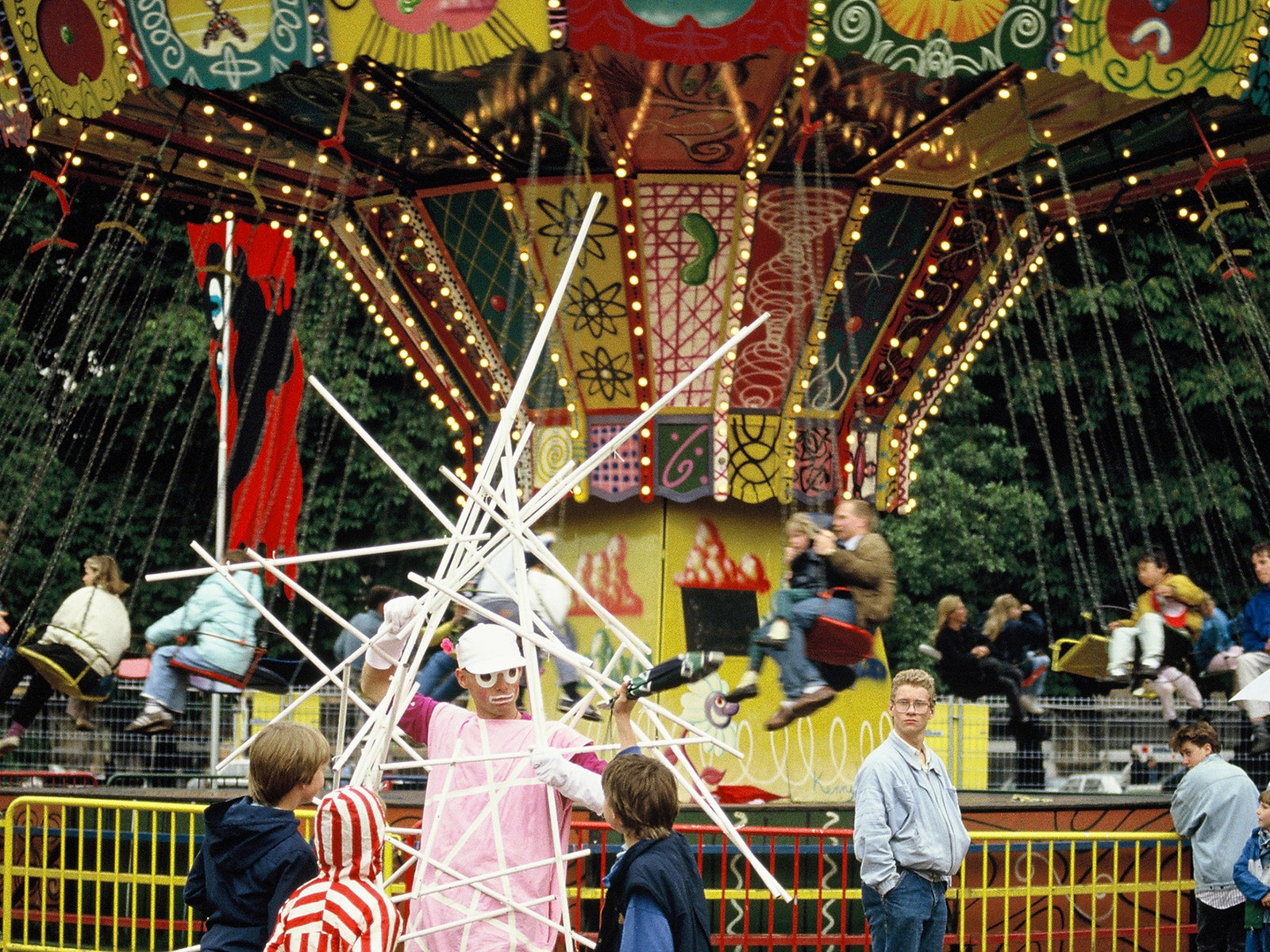 Children and adults on chair swing ride at carnival