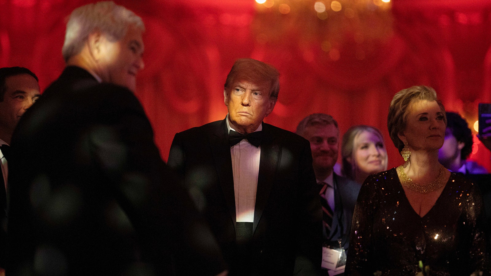 Donald Trump in a tux at a crowded event.