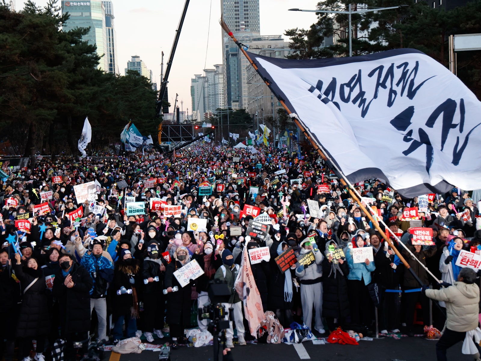 A photo of a crowd cheering after the impeachment of President Yoon Sukyeol in Seoul South Korea in December of 2024.