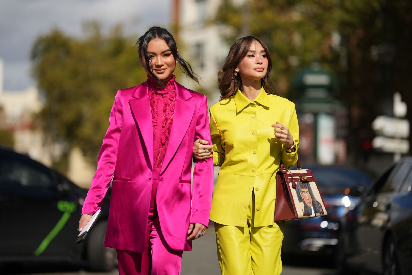 PARIS FRANCE  OCTOBER 01 Nikki Huang wears diamond earrings a neon pink ruffled lace print pattern high neck shirt a...