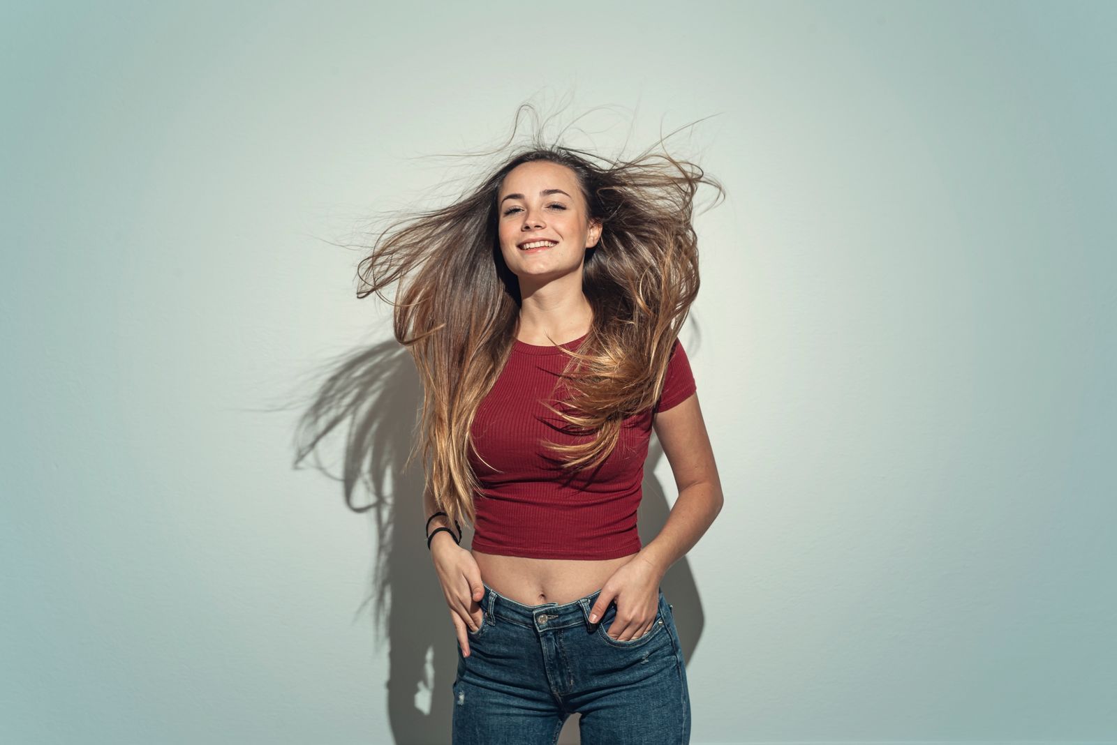 Portrait of a young woman with wind in her hair.Studio shot