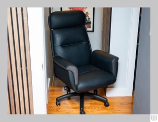 Front view of the Eureka Ergonomic Royal a black office chair with padded back support cushioned sides and extensions...