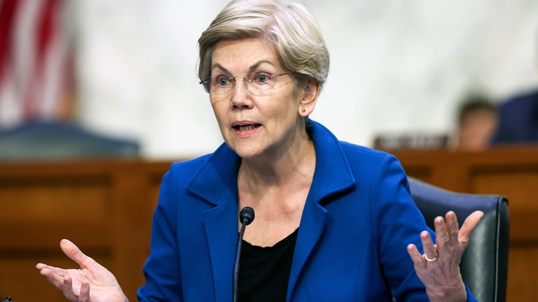 Image may contain Elizabeth Warren People Person Adult Accessories Glasses Jewelry Ring Chair and Furniture