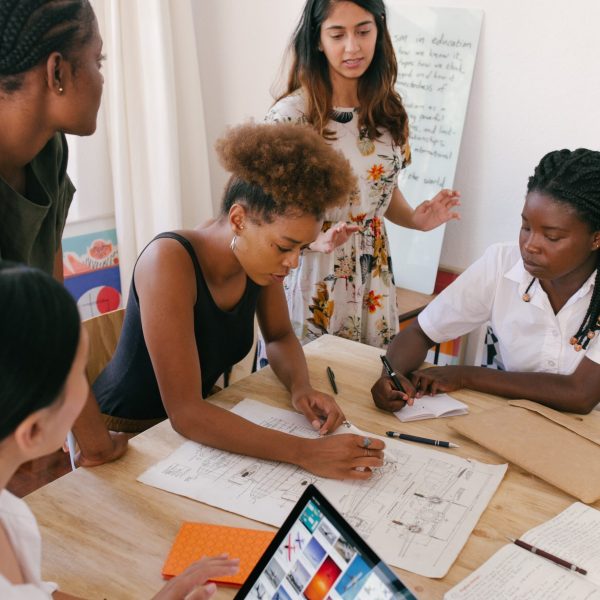 A group of diverse startup founders around a table, participating in a workshop.