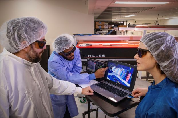 researchers in lab in front of computer