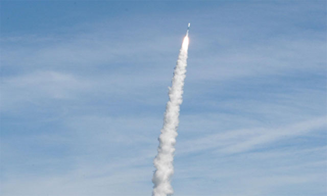 A space shuttle is launched into space. You can see the thick smoke coming from it.