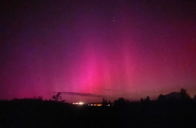 Image showing the night sky with a hot pink and purple aurora.