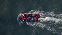 [File photo] This aerial picture taken on September 16, 2023, from a French police aircraft shows migrants onboard a dinghy as they attempt to cross the English Channel.