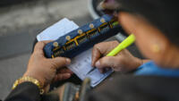 One of Metro Manila's traffic surveyors manually counts passing vehicles from a footbridge in Pasig City