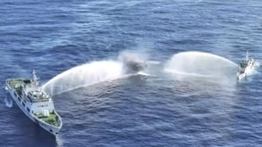 In this image made from video provided by the Philippine Coast Guard, Philippine resupply vessel Unaizah May 4, center, is hit by two Chinese coast guard water canon blasts, causing injuries to multip